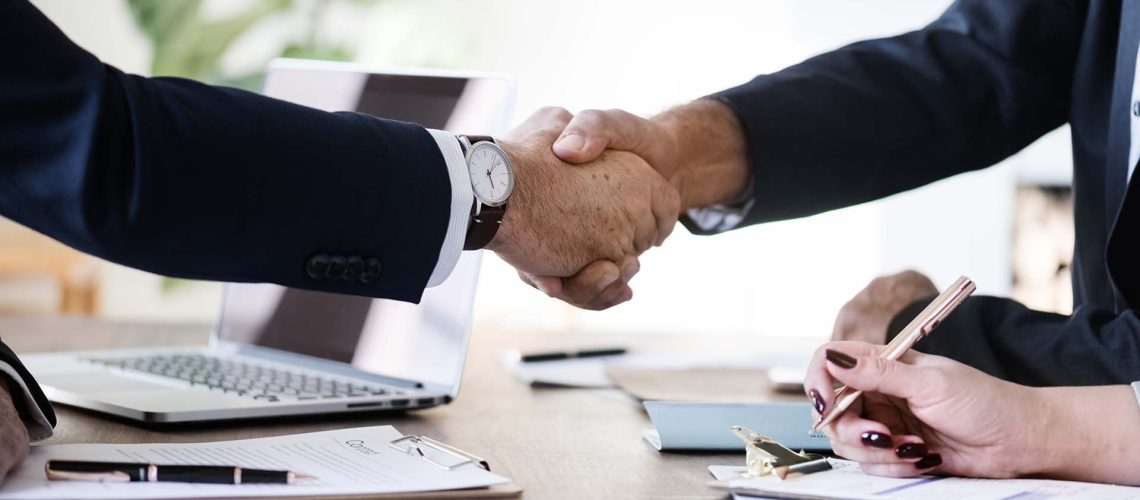Business people shaking hands together